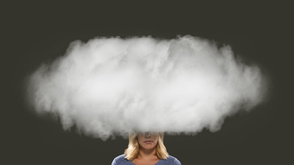 Image of a woman who's head is in smoke cloud illustrating burnout