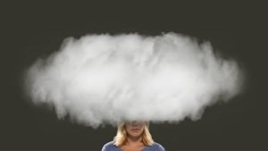 Image of a woman who's head is in smoke cloud illustrating burnout