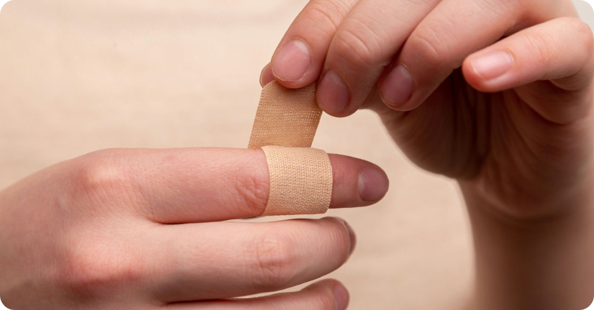 someone puts a band-aid on their finger